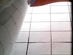 Toilet voyeur spying on a sexy young babe with a perfect ass
